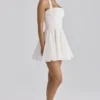 Cosette Weißes Minikleid mit Broderie Anglaise und Baumwoll-Halterausschnitt Cosette Weißes Minikleid mit Broderie Anglaise und Baumwoll-Halterausschnitt