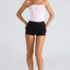 Das trägerlose rosa Stretch-Korsetts-Oberteil Das trägerlose rosa Stretch-Korsetts-Oberteil