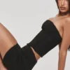 Das trägerlose schwarze Stretch-Korsetts-Oberteil Das trägerlose schwarze Stretch-Korsetts-Oberteil