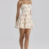 Dolly Elfenbeinfarbenes Vintage-Mini-Sommerkleid aus Baumwolle mit Rosenprint Dolly Elfenbeinfarbenes Vintage-Mini-Sommerkleid aus Baumwolle mit Rosenprint