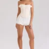 Idella Cremefarbenes Korsetts-Oberteil mit Satin-Spitzenbesatz Idella Cremefarbenes Korsetts-Oberteil mit Satin-Spitzenbesatz