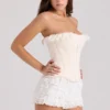 Idella Cremefarbenes Korsetts-Oberteil mit Satin-Spitzenbesatz Idella Cremefarbenes Korsetts-Oberteil mit Satin-Spitzenbesatz