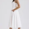 Milia Midi-Kleid aus weißer Broderie Anglais und Baumwolle Milia Midi-Kleid aus weißer Broderie Anglais und Baumwolle
